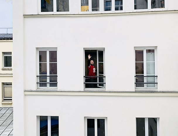Person waving at the window