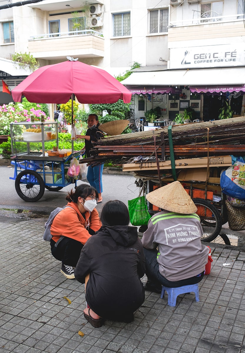 Two students talking to a Vietnamese local